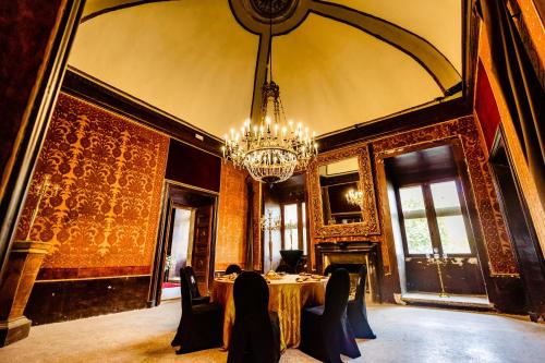 a dining room with a table and a chandelier at Castello Brancaccio in San Gregorio da Sassola