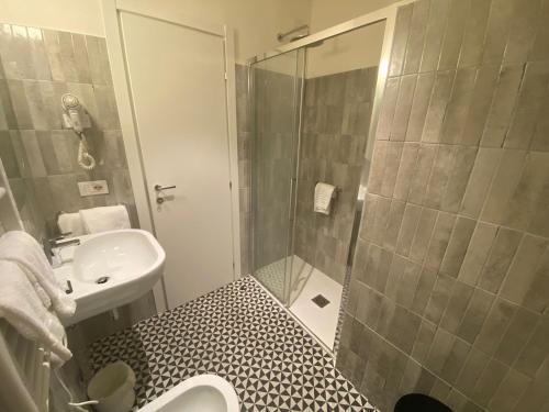 a bathroom with a shower and a toilet and a sink at Hotel Italia e Lido Rapallo in Rapallo