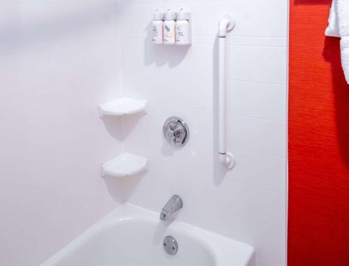 a white bathroom with a sink and a toilet at Sonesta Select Bettendorf in Bettendorf