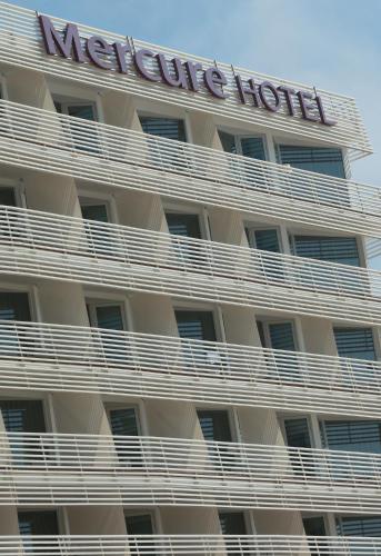 a hotel building with a sign on top of it at Mercure Quemado Al-Hoceima Resort in Al Hoceïma