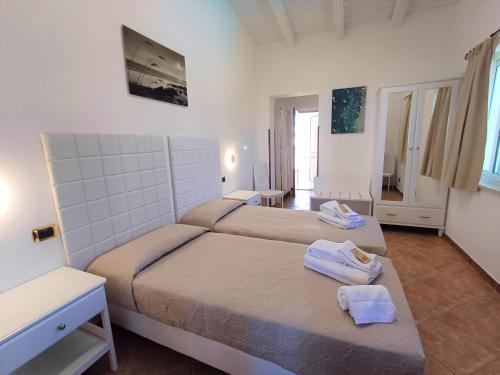 a bedroom with two beds with towels on them at Oasi del Borgo in Borgo Bonsignore