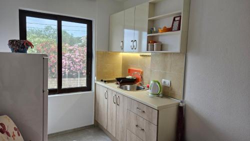 a small kitchen with a sink and a window at Apartments Val Maslina in Utjeha