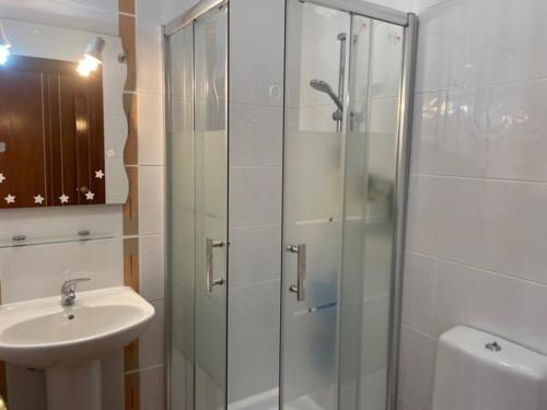 a bathroom with a glass shower and a sink at Paradise Found - Stunning 3 Bedroom Apartment in Vila Real de Santo António in Vila Real de Santo António