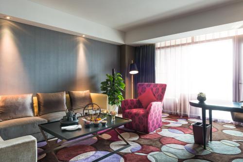 a living room with a couch and a table at Pullman Nanjing Lukou Airport in Nanjing