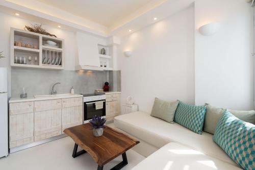 a living room with a couch and a table at Santorita Suites in Akrotiri