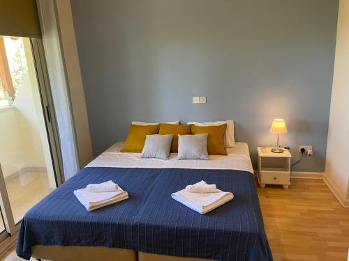 a bedroom with a bed with two towels on it at Protaras Tennis and Country Club in Protaras
