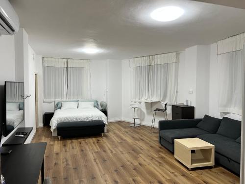 - un salon avec un canapé et un lit dans l'établissement Nazarena Studio Apartment, à Nazareth