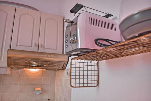 a kitchen with a stove and a toaster oven at Ruby Apartment in Agios Nikolaos