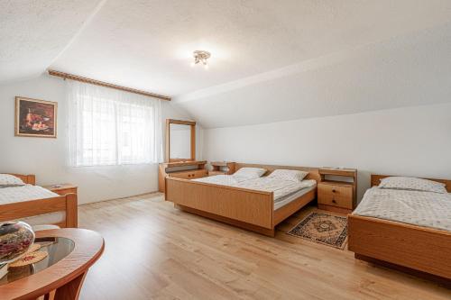 a large room with two beds and a table at Pool House Mržek Family Friendly - Happy Rentals in Nova Vas