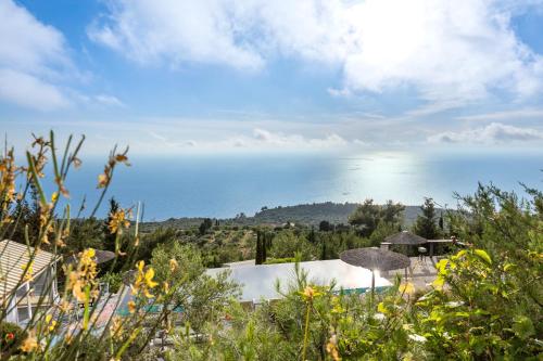 a view of the ocean from a house at Serenity Boutique Suites in Athanion