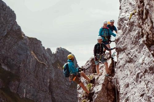 a group of three people climbing on a mountain at Hotel St. Georg zum See in Maurach