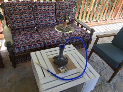 a lamp on a table next to a couch at Villa Green Heaven in Sarajevo