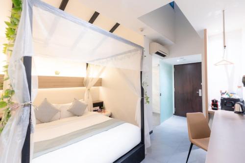 a bedroom with a bed with a canopy at Hotel NuVe in Singapore