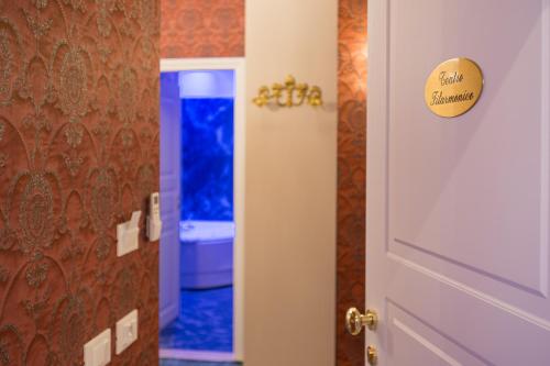 a door to a bathroom with a blue toilet at Royal Verona Relais in Verona