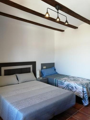 a bedroom with two beds in a room at Casa Las Torres in Mora de Rubielos