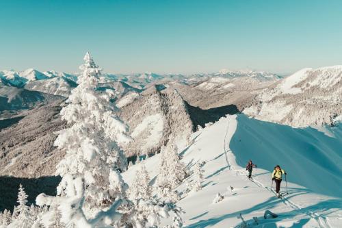 two people skiing down a snow covered mountain at Hotel St. Georg zum See in Maurach