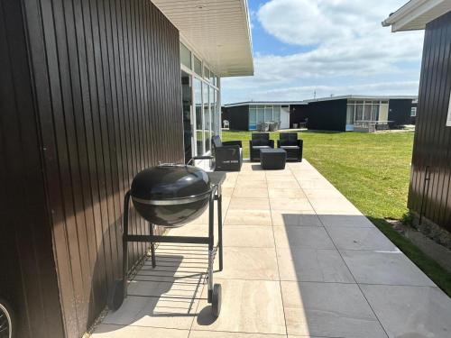 a grill on a cart on the side of a building at Beautiful Chalet, 18 Cordova, Selsey Country Club in Selsey