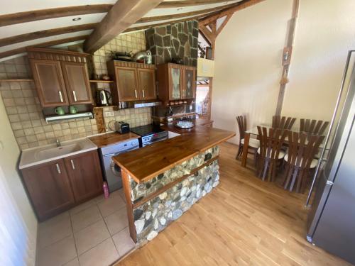 a kitchen with wooden cabinets and a counter top at КЪЩА ЗА ГОСТИ ВОДЕНИЦАТА in Devin