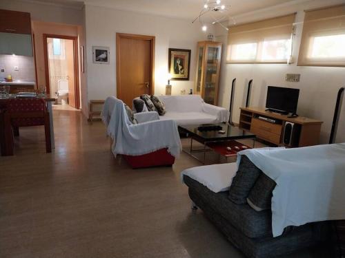a large living room with a couch and a table at Cozy apartment close to the sea in Perea