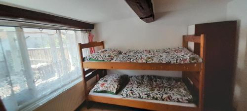 two bunk beds in a room with a window at chalupa žamberk in Žamberk