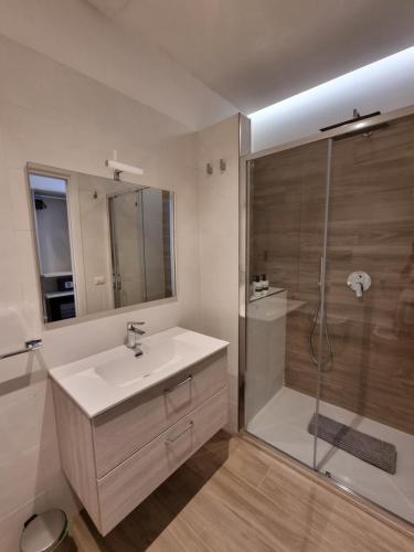 a bathroom with a sink and a shower at Marea Retreat Rooms in Marina di Camerota