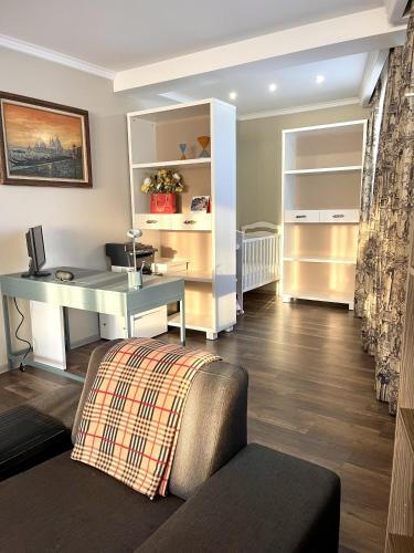 a living room with a desk and a couch at Holiday Home Barska Vila in Bar