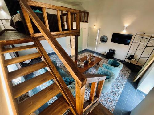 an overhead view of a living room with a wooden staircase at Castello Brancaccio in San Gregorio da Sassola