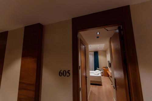 a hallway with a mirror and a sink in a room at Hotel Marwa Tashkent Pool&Spa in Tashkent