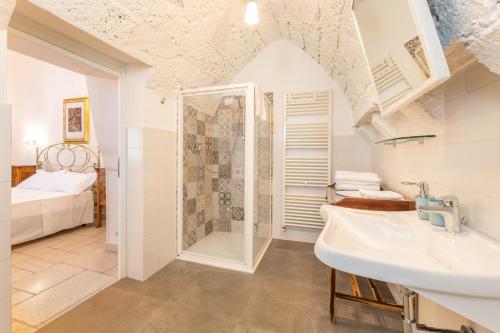 a bathroom with a shower and a sink at Luxury Courtyard in Racale