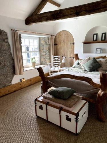 a bedroom with a large bed and a large window at The Little Grebe in Swansea