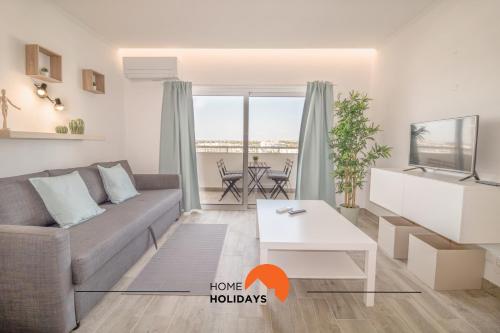 a living room with a couch and a table at #048 Sea and City view with Pool, AC in Brejos