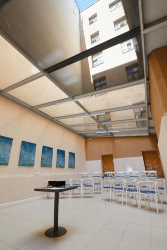 a room with a table and chairs in it at Stabu Sēta Residence in Rīga