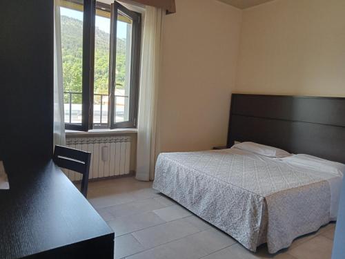 Een bed of bedden in een kamer bij Hotel Porta Rivera Plesso Stazione