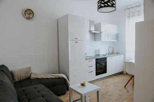 a living room with a couch and a kitchen at Apartman Nikola in Gospić