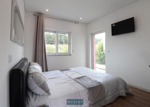 En eller flere senge i et værelse på MyStay - Casa do Louro