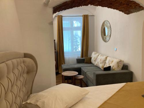 a living room with a couch and a couch and a table at Old Town Sibiu Studio - Historical Center Residence in Sibiu