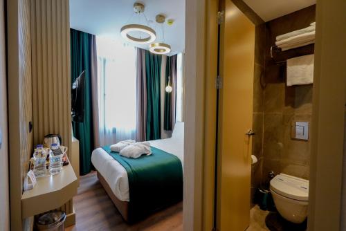 a hotel room with a bed and a bathroom with a toilet at THE NEST HOTEL in Istanbul