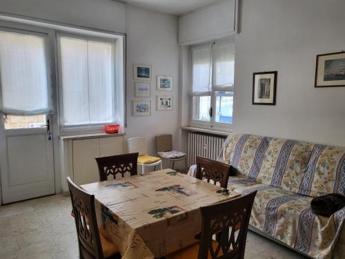 a living room with a table and a couch at Marina's house in Imperia