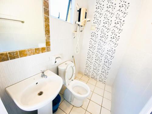 a bathroom with a toilet and a sink at Sun Inns Hotel Bandar Puchong Utama in Puchong