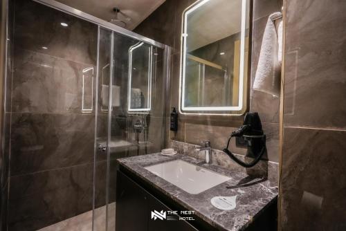 a bathroom with a sink and a shower at THE NEST HOTEL in Istanbul