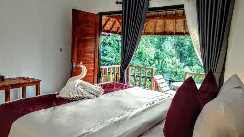 Tempat tidur dalam kamar di Vina Bungalow