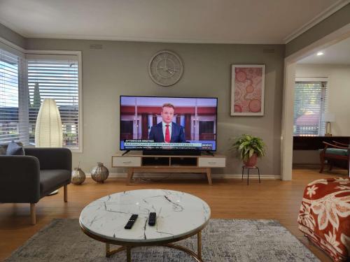 a living room with a flat screen tv on a wall at Home in Frankston in Frankston