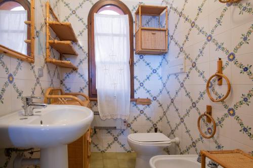 a bathroom with a sink and a toilet at HelloElba Appartamento Le Tortore in Portoferraio