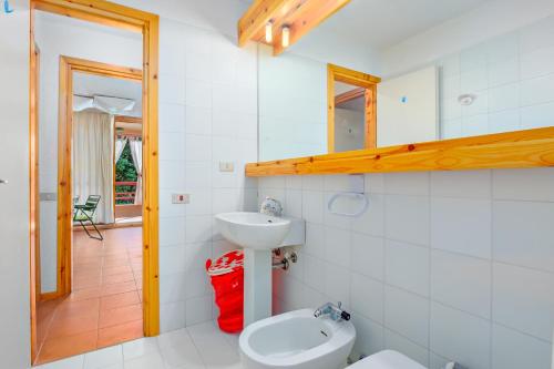 a bathroom with a toilet and a sink at Casa Vacanza Libeccio 2417 in Cugnana