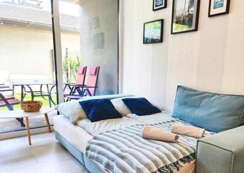 a living room with a couch and a table at Petit Paul Apartman in Keszthely