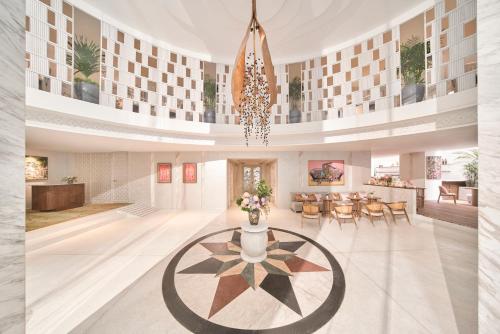 a rendering of a lobby with a table and chairs at Silverland Mây Hotel in Ho Chi Minh City