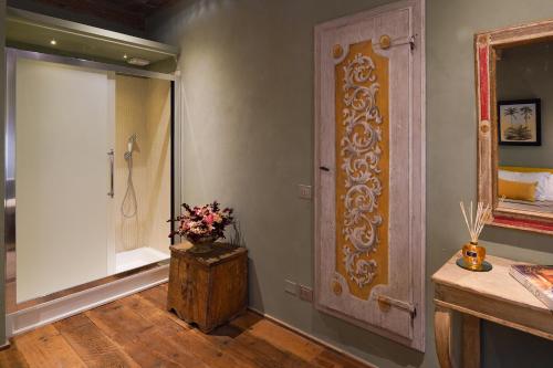 a bathroom with a walk in shower and a door at Borgo Signature Rooms in Florence