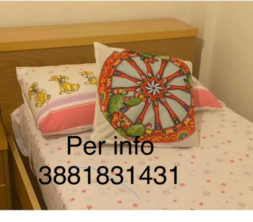 a bed with a ferris wheel pillow on it at Marsala beddra lu suli, lu Mari e lu ventu in Marsala