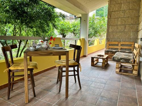 a table and chairs on a patio with a window at Locanda Su mere b&d in Cheremule