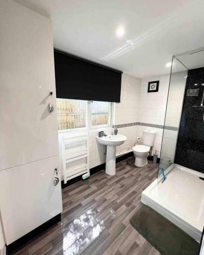 a bathroom with a sink and a toilet and a shower at Willow Inn in Kent